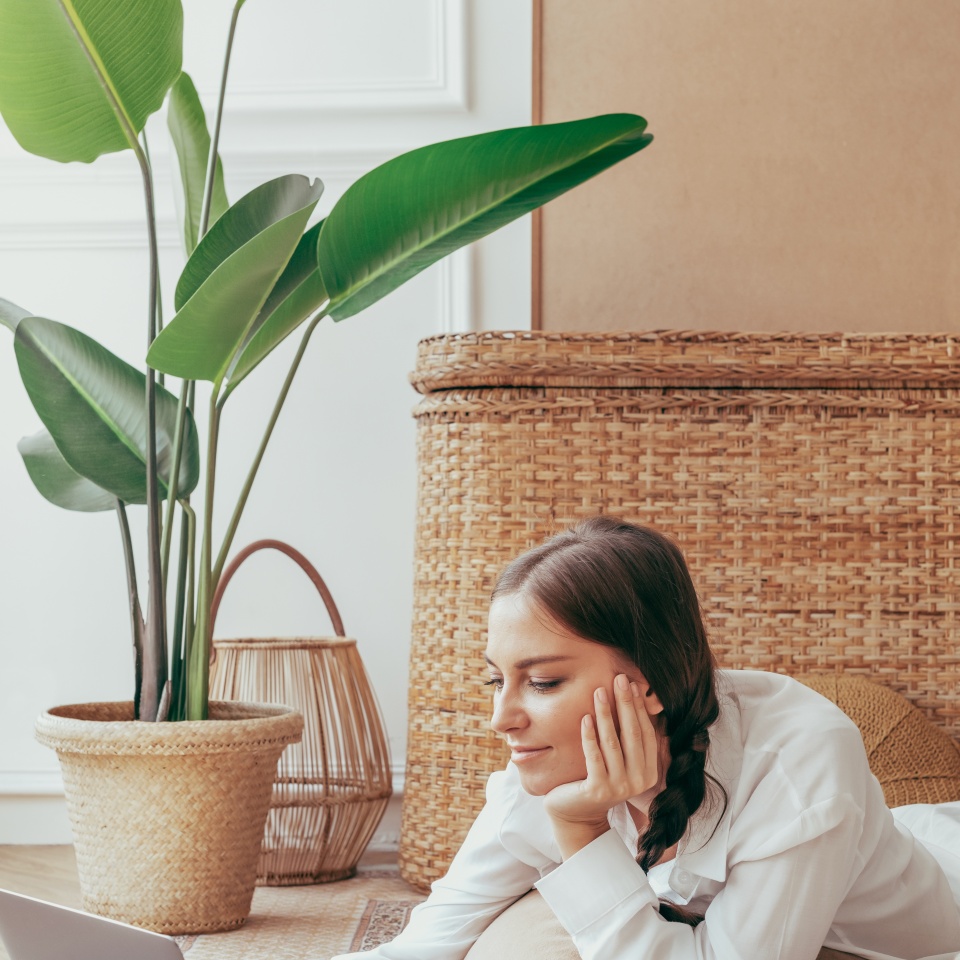 Woman using laptop on the floor. Woman lay chilling on the floor and using tablet at home. Wonman. Woman relaxing at home by using table. Woman relaxing at living room with using laptop.