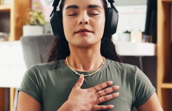 Woman, relax and audio therapy with headphones for zen, breathing exercise or technique in home. Female person, yoga and relaxation with sound in meditation for inner peace, mindfulness or balance
