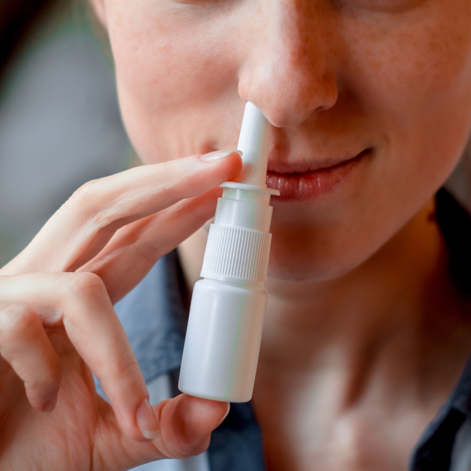 Medicine nose, nasal spray or drops for health in white bottle, container in hand or palm from cold, flu, illness. Liquid pharmacy, care or treatment. Medical object, drug.
