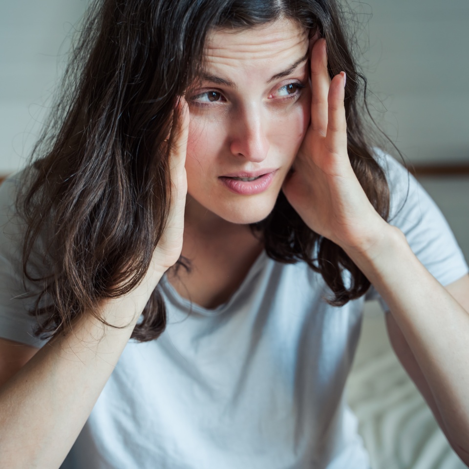 Sad, unhappy woman in depression. Headache, stress, anxiety tension, psychological problems. Poor mental health, visiting psychologist, psychotherapy session. Worries about work,family divorce.