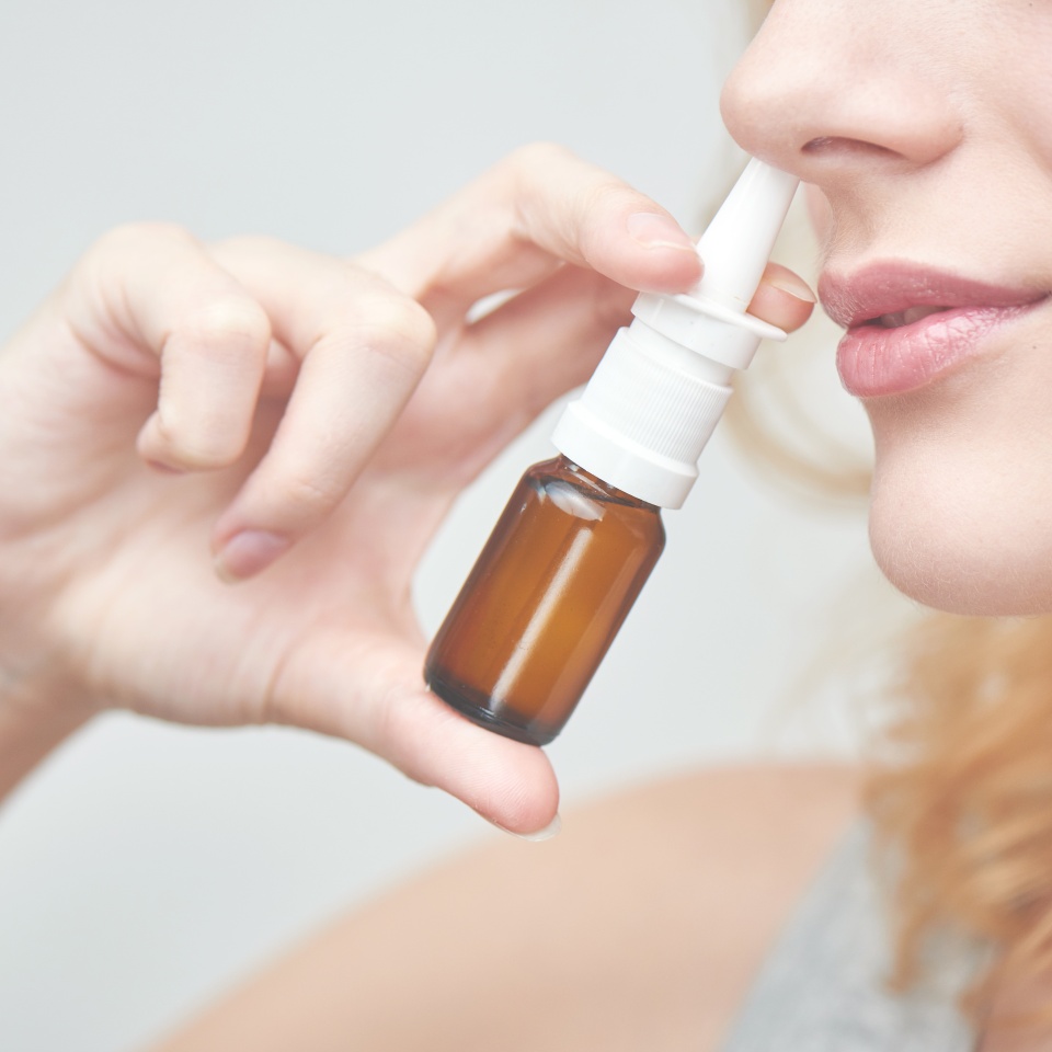 The treatment of rhinitis. Girl dripping nose drops